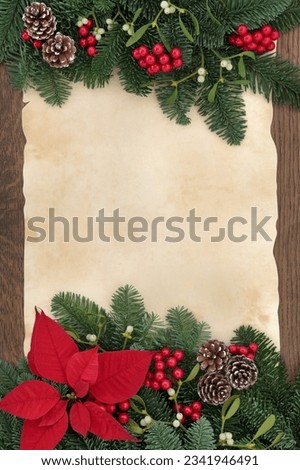 Winter and christmas floral border with red poinsettia flower, bauble decorations, mistletoe, pine cones and spruce fir over paper parchment and oak wood background.