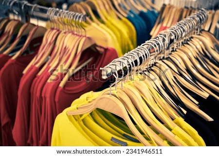 Clothing and retail store- view of clothes shop with t-shirt hanged on stand
