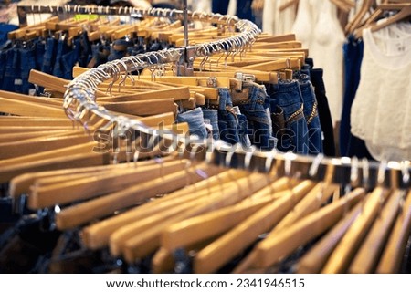 Clothing and retail store- view of clothes shop with jeans hanged on stand