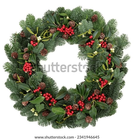 Winter and christmas floral wreath with holly, ivy, mistletoe and spruce fir over white background.