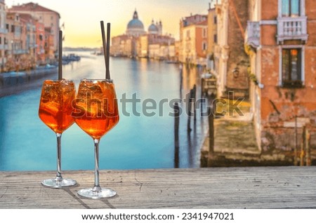 two Aperol Spritz in Venice, in the background the view from the Accademia Bridge Royalty-Free Stock Photo #2341947021