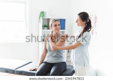 A Modern rehabilitation physiotherapy clinic with professional and client Royalty-Free Stock Photo #2341947813