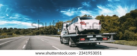 Car Service Transportation Concept. Tow Truck Transporting Car Or Help On Road Transports Wrecker Broken Car. Auto Towing, Tow Truck For Transportation Faults And Emergency Cars . Tow Truck Moving In Royalty-Free Stock Photo #2341953051