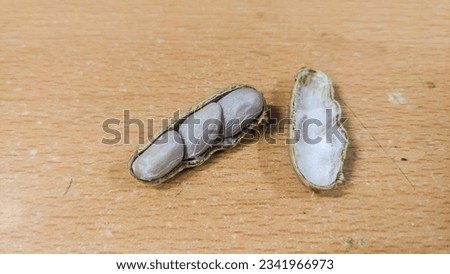 Pile group of boiled peanut, boiled peanut bean fall down pour on ground. Tropical boiled peanut shot close up. White background Isolated high speed shutter, freeze action

