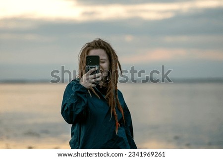Young woman taking a picture.