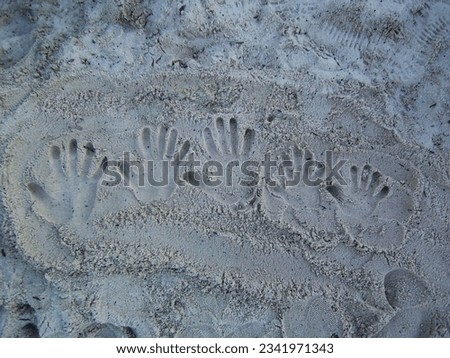 Five hand imprinted in sand Royalty-Free Stock Photo #2341971343