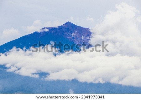 Mount Kerinci (Gunung Kerinci) is the highest mountain in Sumatra, the highest volcano and the highest peak in Indonesia with an altitude of 3805 masl, located in the Kerinci Seblat National Park area Royalty-Free Stock Photo #2341973341