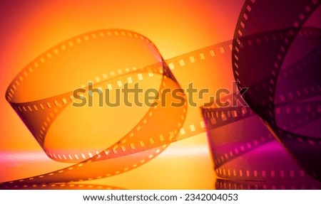 colorful abstract background with film strip.orange magenta background with film strip for background Royalty-Free Stock Photo #2342004053