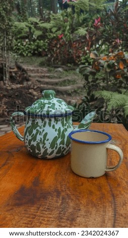 Surabaya, 4 August 2023. Indonesian traditional teapot and glass for serving hot tea or coffee. 