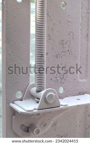 threaded lever of a grinding machine in an industrial room. engine parts covered in white dust