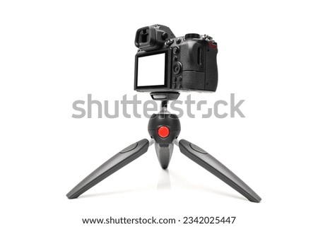 Mirrorless camera on a tripod for live or streaming, mockup camera isolated with clipping path on a white background Royalty-Free Stock Photo #2342025447