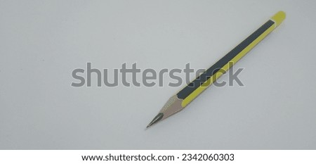 This is a yellow pencil with black lines, sharp, pointed.