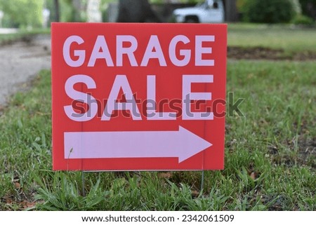 Garage Sale Sign in Grass with Arrow Pointing Right, Small Town USA