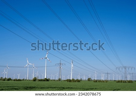 Wind trubines and electric power lines seen in Germany Royalty-Free Stock Photo #2342078675