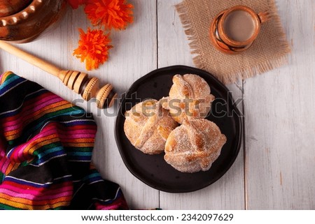 Pan de Muerto. Typical Mexican sweet bread that is consumed in the season of the day of the dead. It is a main element in the altars and offerings in the festivity of the day of the dead. Royalty-Free Stock Photo #2342097629
