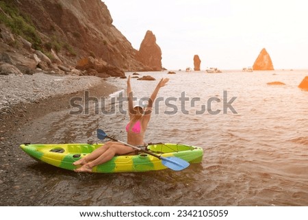 Woman kayak sea. Happy tourist enjoy taking picture outdoors for memories. Woman traveler posing in kayak canoe at sea surrounded by volcanic mountains, sharing travel adventure in kayak