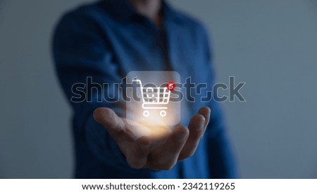 Businessman hold smartphone with online shopping concept, marketplace website with virtual interface of online Shopping cart part of the network, Online shopping business with selecting shopping cart. Royalty-Free Stock Photo #2342119265