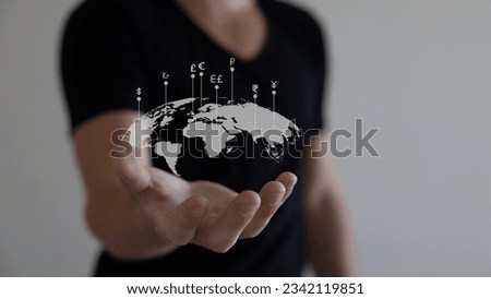 Global currency exchange concept, Hand holding world with virtual line effect and dollar yuan yen euro and pound sterling sign.