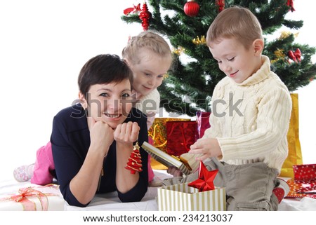 Mother and two children opening Christmas presents