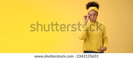 Unsure thoughtful hesitant cute african-american millennial teenage girl in round glasses sweater headband solving riddle mind look up doubtful touch eyewear smirking, thinking yellow background.