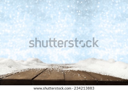blue winter fuzzy background and free space on wooden table 
