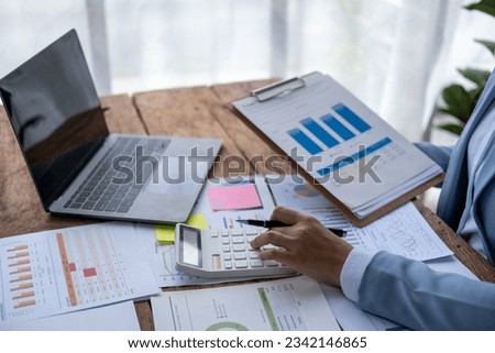 Closed up Business owner sale manager accountant working taxes calculation firm law accounting on calculator laptop computer Royalty-Free Stock Photo #2342146865