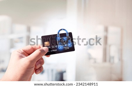 Close up of man hand holding credit or debit card with padlock, protection of financial transactions, copy space, Financial security technology concept. Royalty-Free Stock Photo #2342148911
