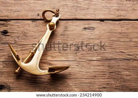 Anchor on wood background