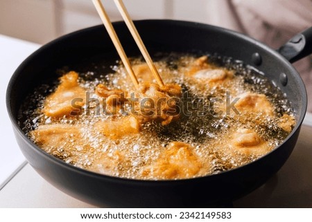 Chicken fried in frying pan Royalty-Free Stock Photo #2342149583