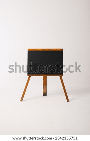 Black sign in wooden frame and copy space on white background. Signage, writing space and advertising concept.
