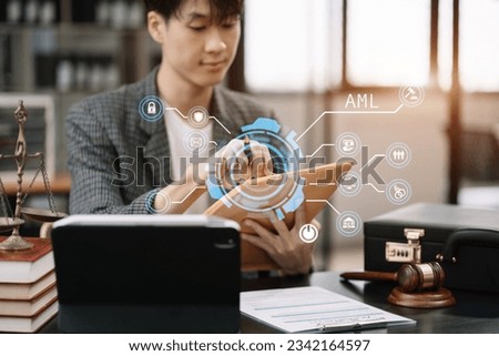 Male Legal counsel working with paperwork on his desk in office workplace working with tablet computer. Justice and law concept.