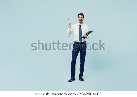 Full body young employee IT business man corporate lawyer wear classic shirt tie work in office hold clipboard with paper account documents point pen up pov new idea isolated on plain blue background Royalty-Free Stock Photo #2342184083