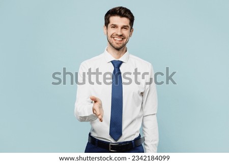 Young fun successful employee business man corporate lawyer wear classic formal shirt tie work in office hold hand in handshake gesture isolated on plain pastel light blue background studio portrait Royalty-Free Stock Photo #2342184099