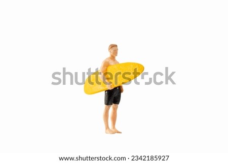 Miniature people man in a swimsuit, and holding a yellow surfboard, isolated on white background with clipping path Royalty-Free Stock Photo #2342185927