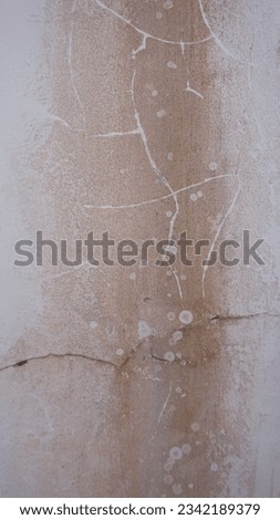 The faded color of the wall on the clothesline