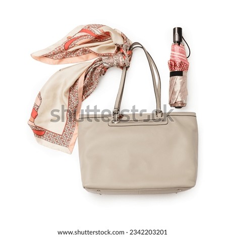 Leather women's handbag with an umbrella and a neckerchief on a white background Royalty-Free Stock Photo #2342203201