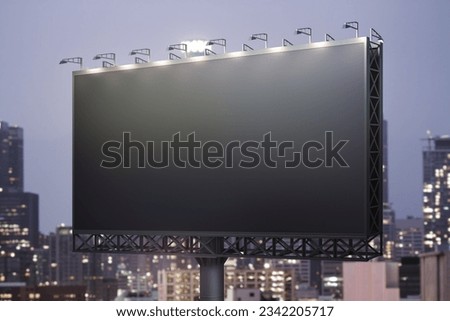 Blank black horizontal billboard on cityscape background at night, perspective view. Mockup, advertising concept