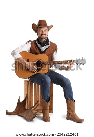 Handsome cowboy playing guitar on white background Royalty-Free Stock Photo #2342212461