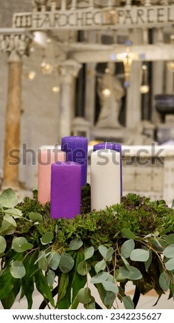 Multi-colored candles burn in the church