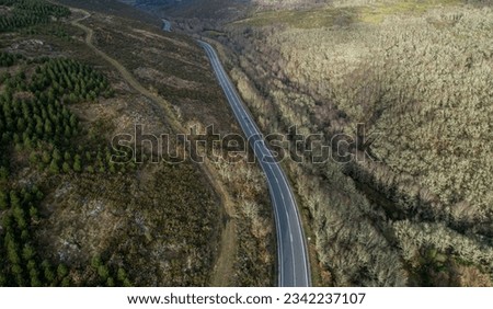 drone aerial view of a mountain road in wintertime