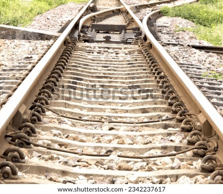 a photography of a train track with a train car on it, there is a train track that has a bunch of tracks on it.