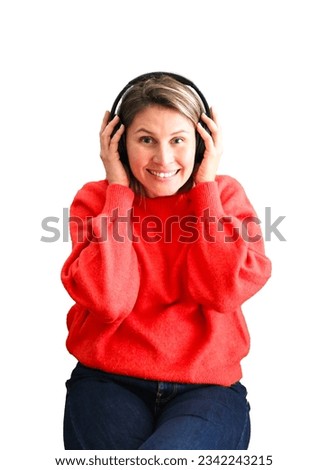 Beautiful young blonde woman smiling while wearing headphones against a white background