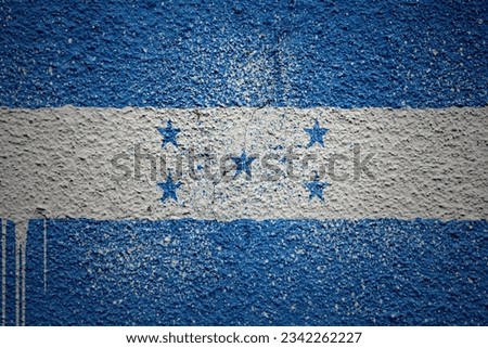 colorful painted big national flag of honduras on a massive old cracked wall