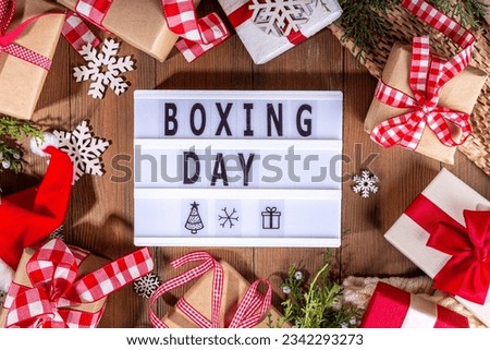 Boxing day sale seasonal promotion background. Various presents gift box with ribbon, with inscription frame Boxing day, block wooden calendar, wrapping holiday paper, Christmas decor, ribbons Royalty-Free Stock Photo #2342293273