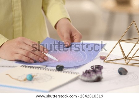 Astrologer using zodiac wheel for fate forecast at table, closeup. Fortune telling Royalty-Free Stock Photo #2342310519