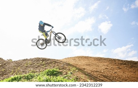 Mountain bike, man and jump in sky for competition, freedom and off road adventure. Athlete, extreme sports and bicycle in air for action, cardio race and stunt power in nature, path and mockup space