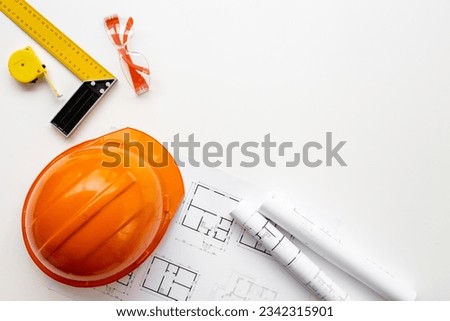 Construction drawing blueprints with helmet, top view. house designing and architect plan concept. Royalty-Free Stock Photo #2342315901