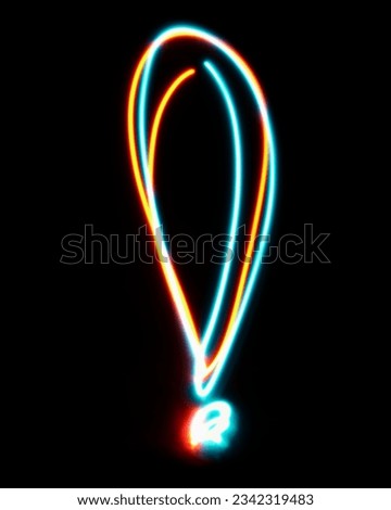 Exclamation mark made from neon sign. The blue red light image, long exposure with colored fairy lights, against a black background. Concept of design