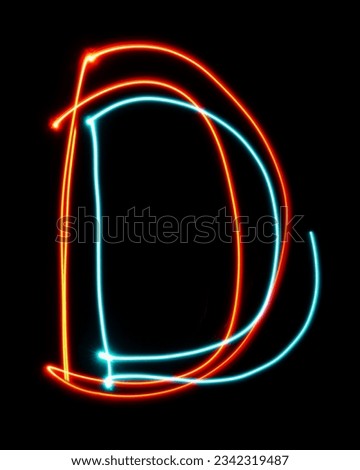Letter D of the alphabet made from neon sign. The blue red light image, long exposure with colored fairy lights, against a black background. Concept of design
