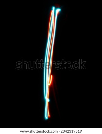 Letter I of the alphabet made from neon sign. The blue red light image, long exposure with colored fairy lights, against a black background. Concept of design Royalty-Free Stock Photo #2342319519